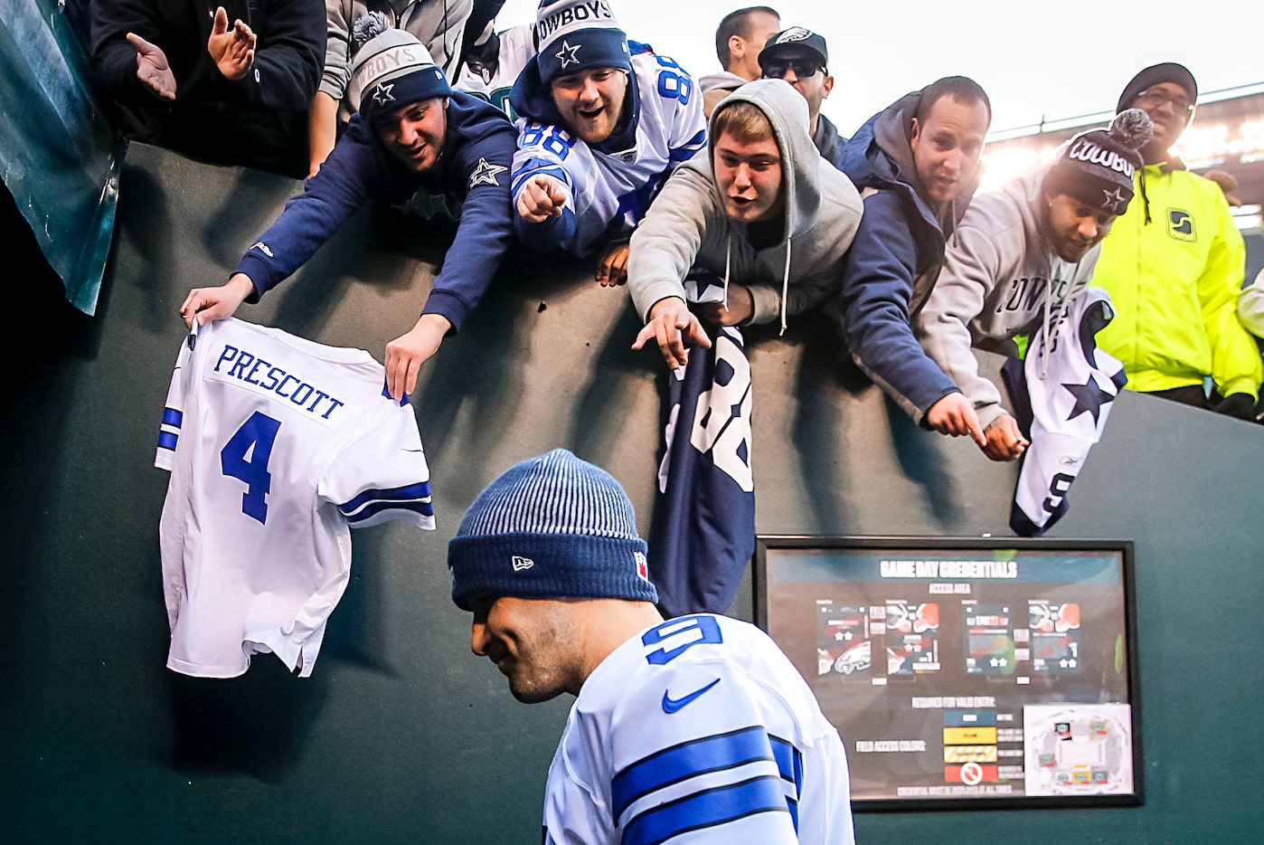 Fans yell to Dallas Cowboys quarterback Tony Romo as he walks off the field after a loss to...