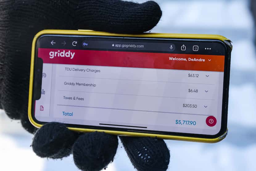 DeAndré Upshaw shows a $5,000 bill from Griddy on his cellphone for his 900-square-foot...