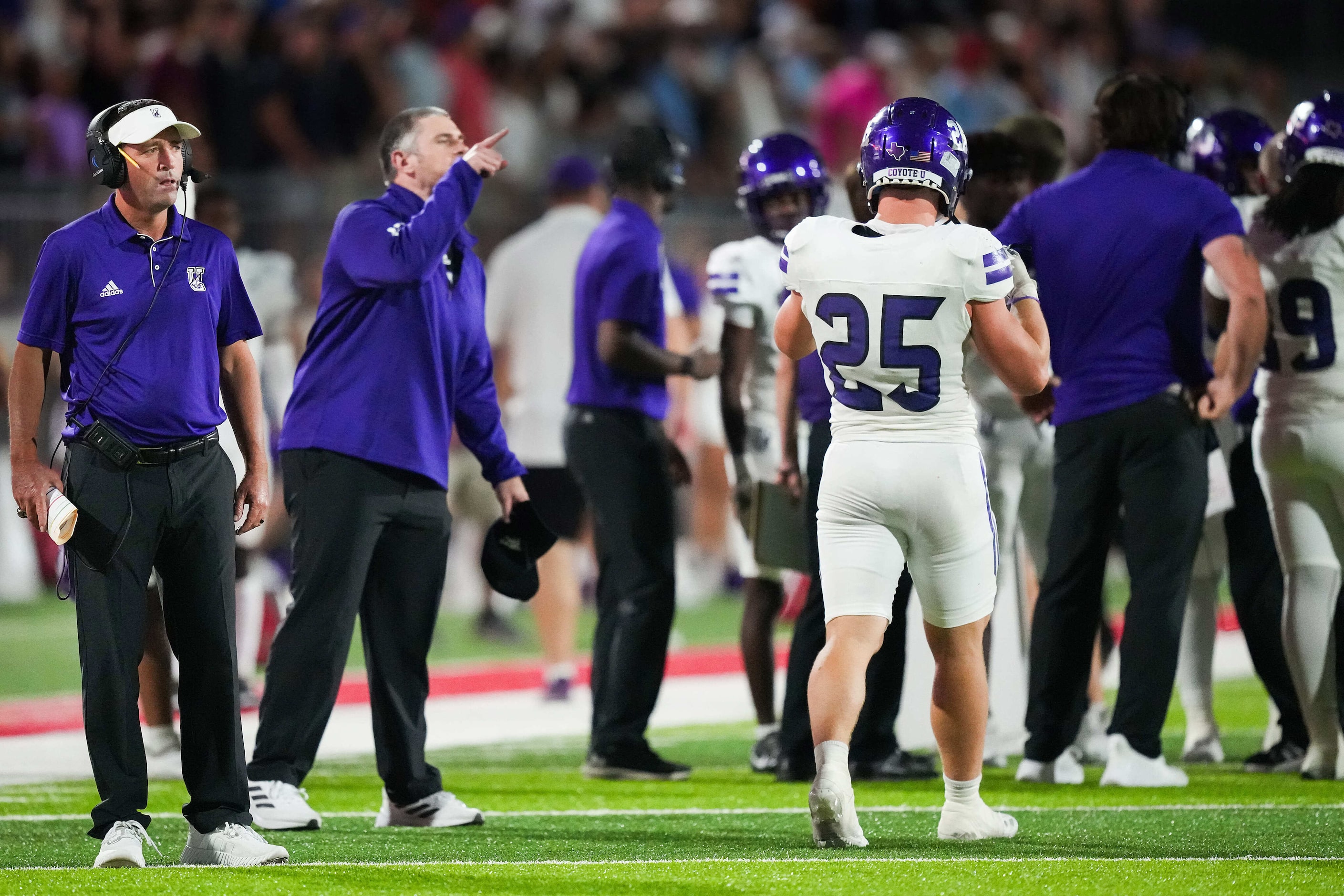 Anna head coach Seth Parr (left) looks on from the sidelines after a fumble by quarterback...