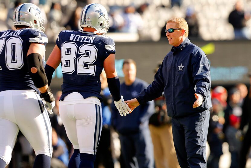 Dallas Cowboys head coach Jason Garrett shakes hands with tight end Jason Witten (82) during...