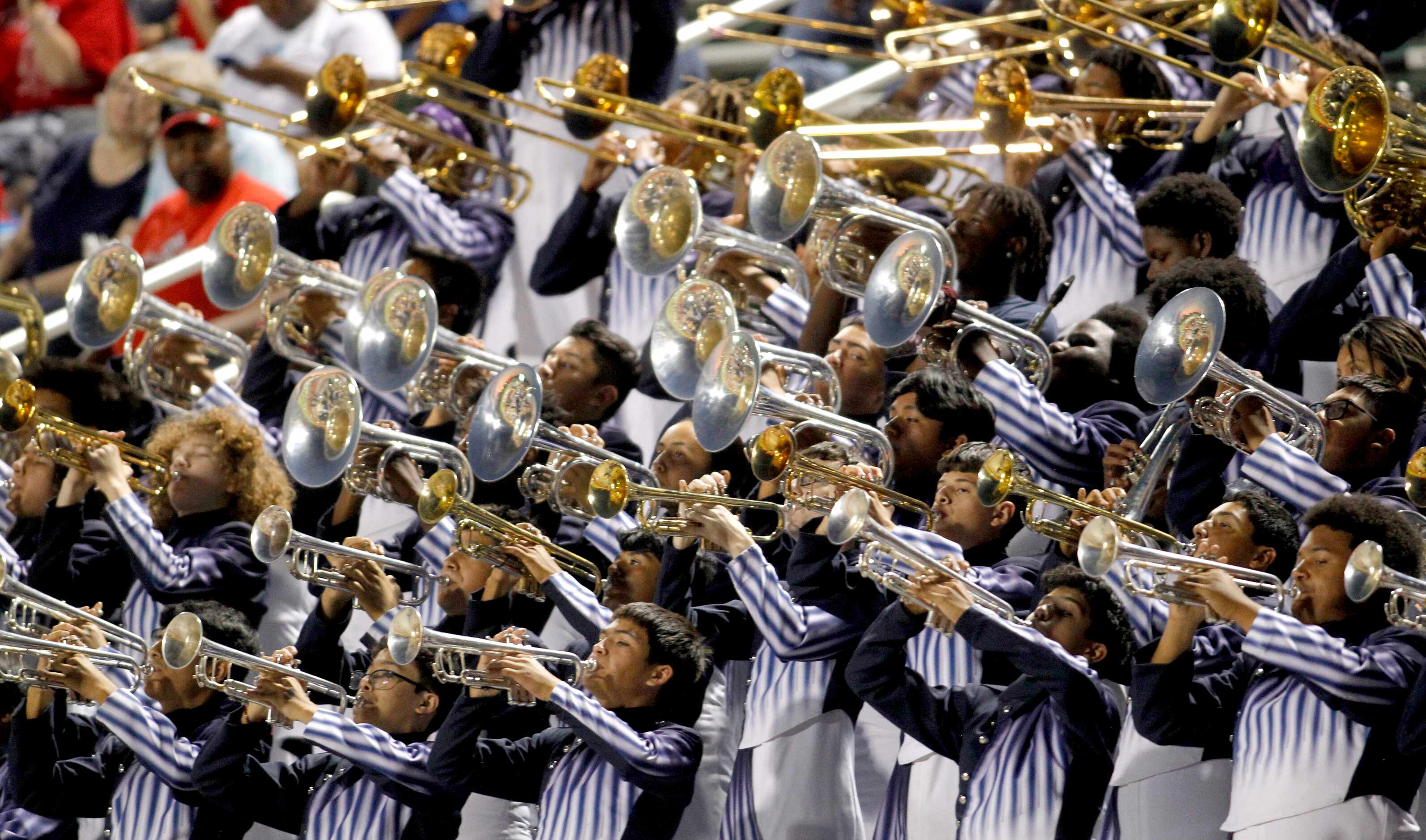 Members of the Duncanville high school band perform from the stands during first half action...
