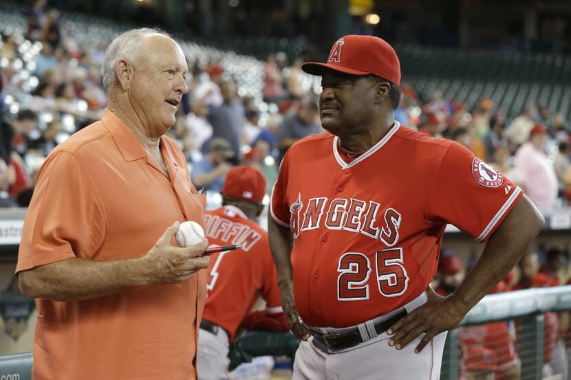 Former Houston Astros pitcher Nolan Ryan, left, talks with Los Angeles Angels batting coach...