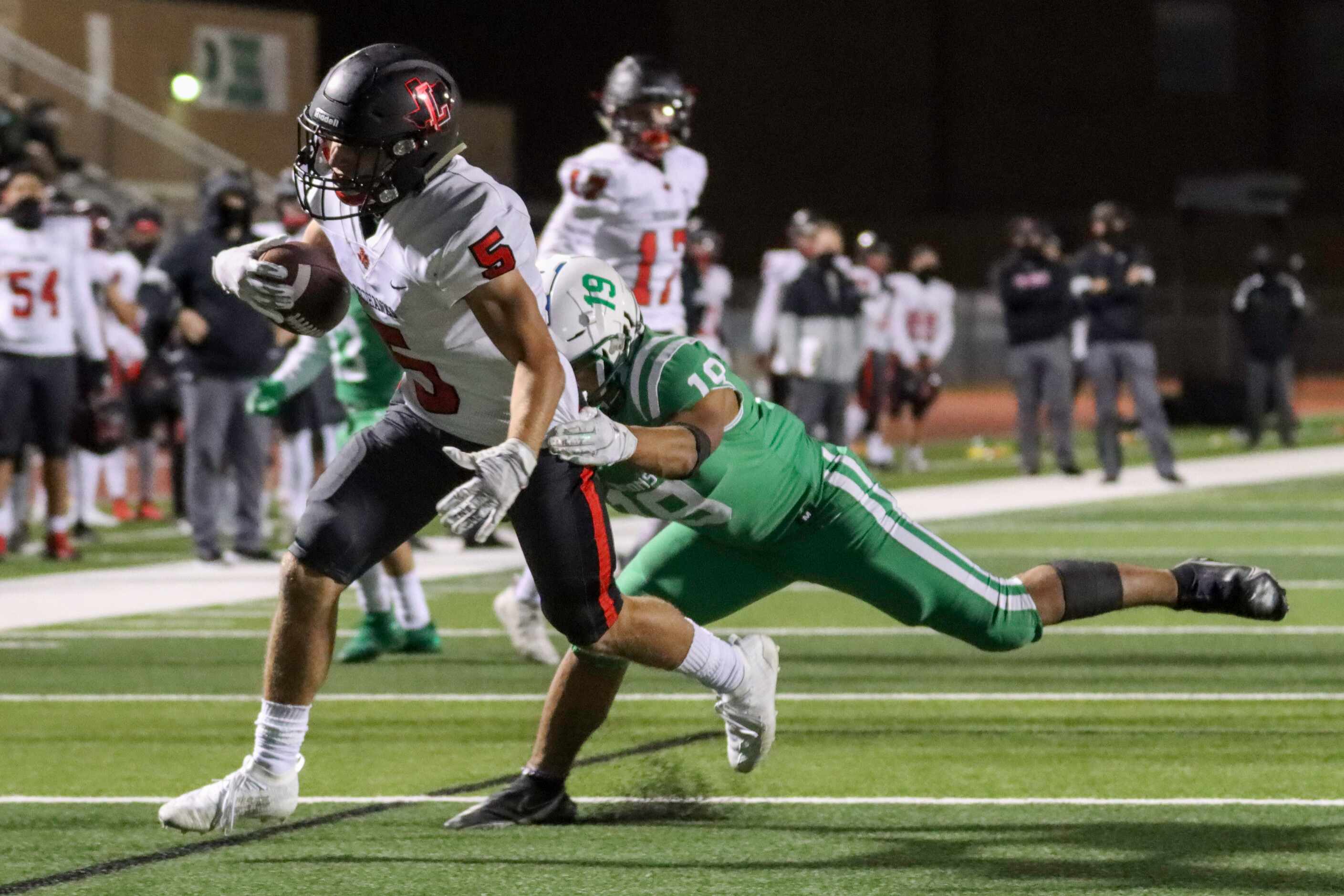 Lake Dallas defensive back Anthony Lunca (19) tries to tackle Frisco Liberty running back...