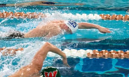 Keller’s Cooper Lucas, center, competes in the 200 freestyle during the 2023 UIL Swim & Dive...