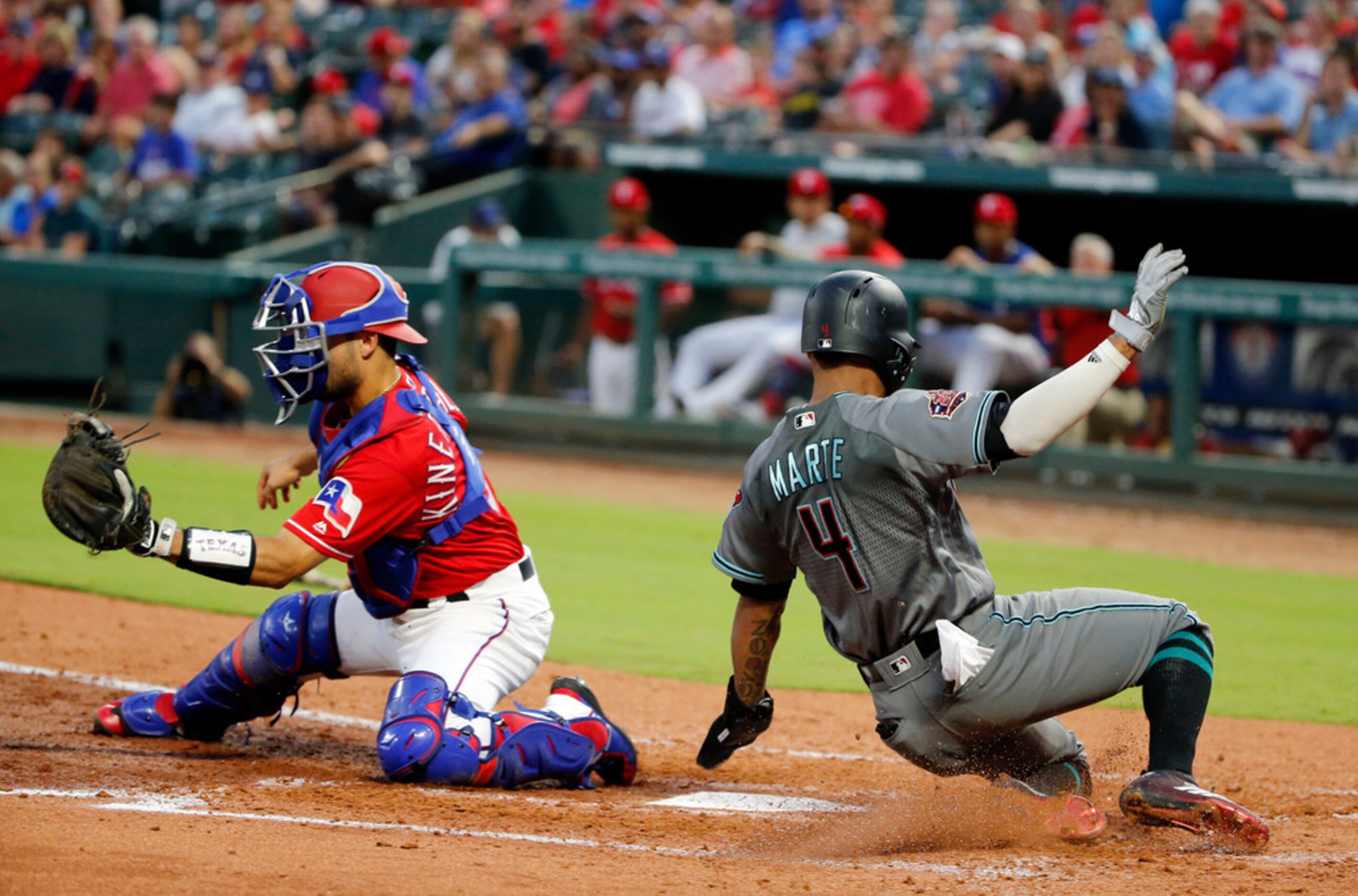 Arizona Diamondbacks' Ketel Marte (4) scores as Texas Rangers catcher Isiah Kiner-Falefa...