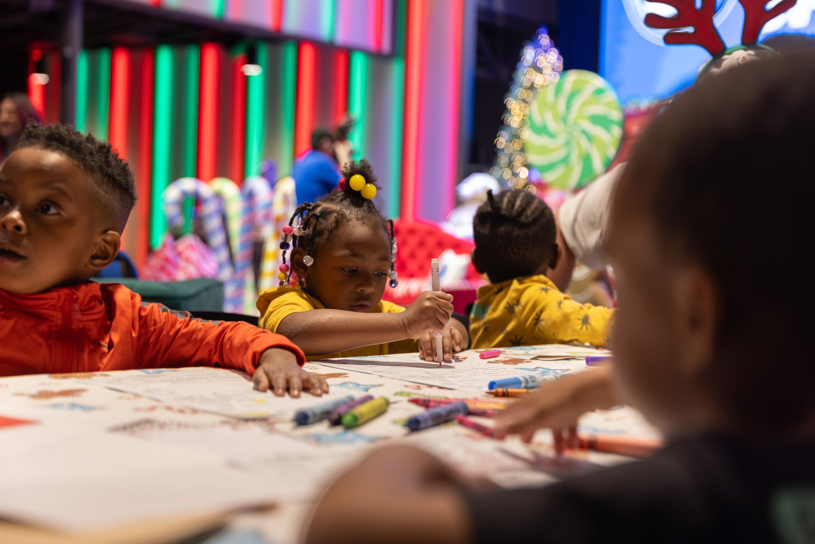 Kids do arts and crafts during the Cookies With Santa event in Dallas on Dec. 20, 2024. 