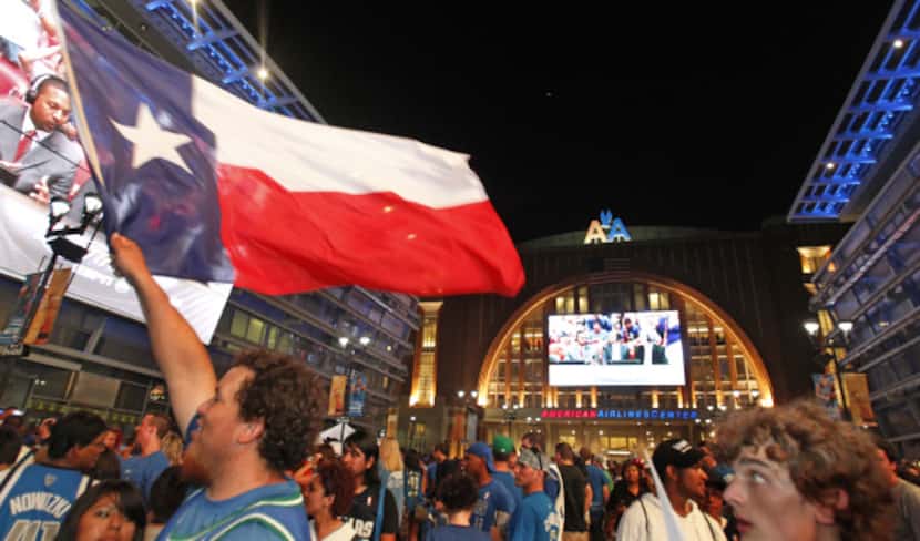 Fans celebrate outside the arena after the Mavs beat the Miami, at the watch party at the...