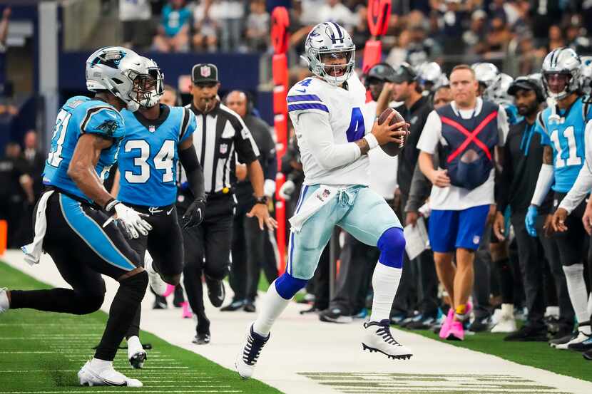 Dallas Cowboys quarterback Dak Prescott (4) scrambles for a first down against Carolina...