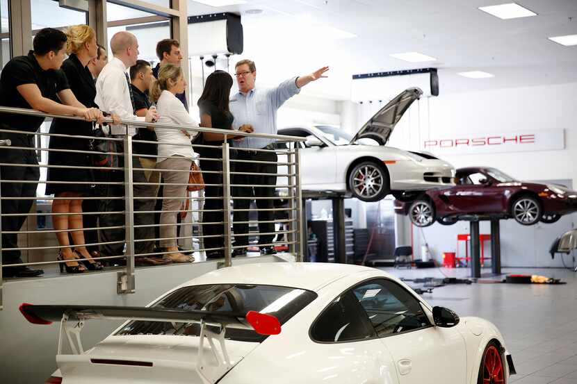 Training manager Patrick Gardner (right) leads a group of new employees on a tour of the...