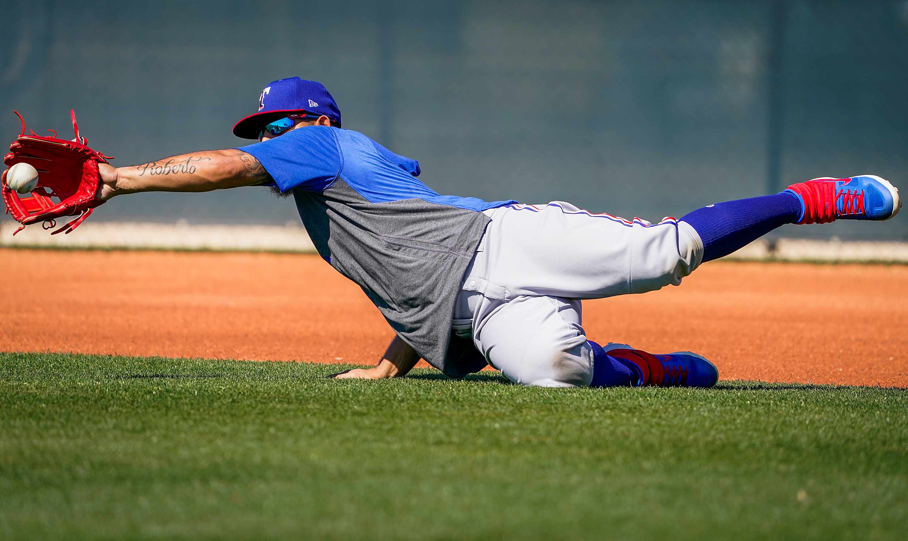 Texas Rangers second baseman Rougned Odor makes a catch in a fielding drill during a spring...
