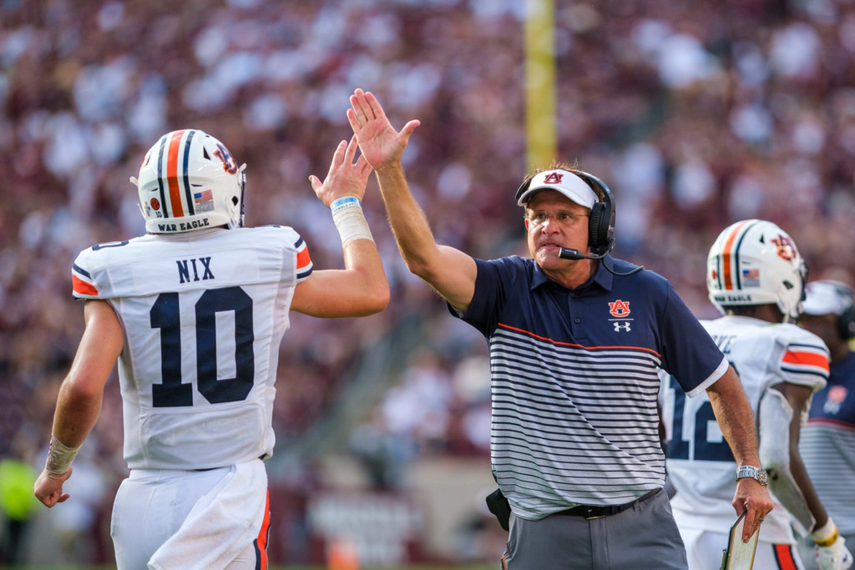 Auburn head coach Gus Malzahn celebrates with quarterback Bo Nix (10) after a Tigers...