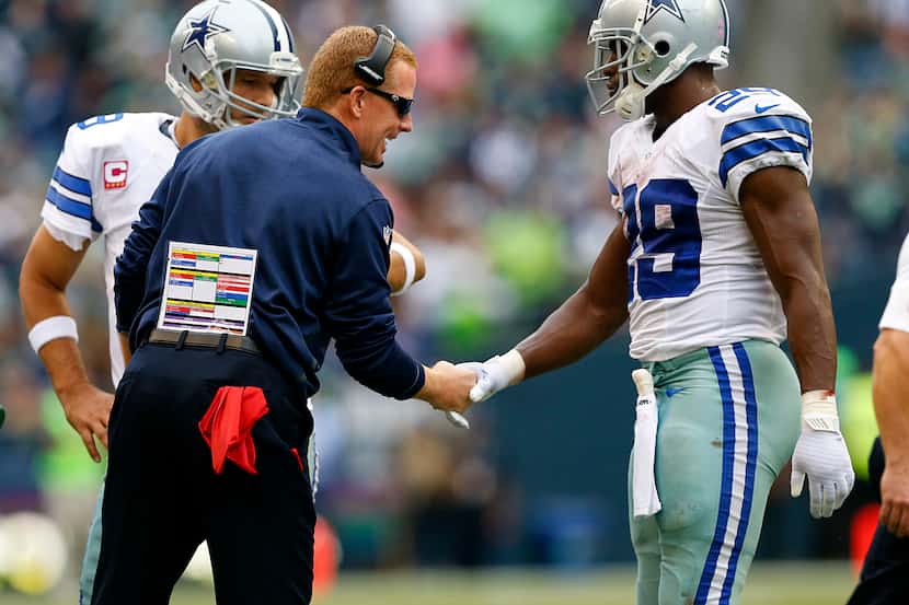 Dallas Cowboys head coach Jason Garrett questions a call from head linesman Jerry Bergman...