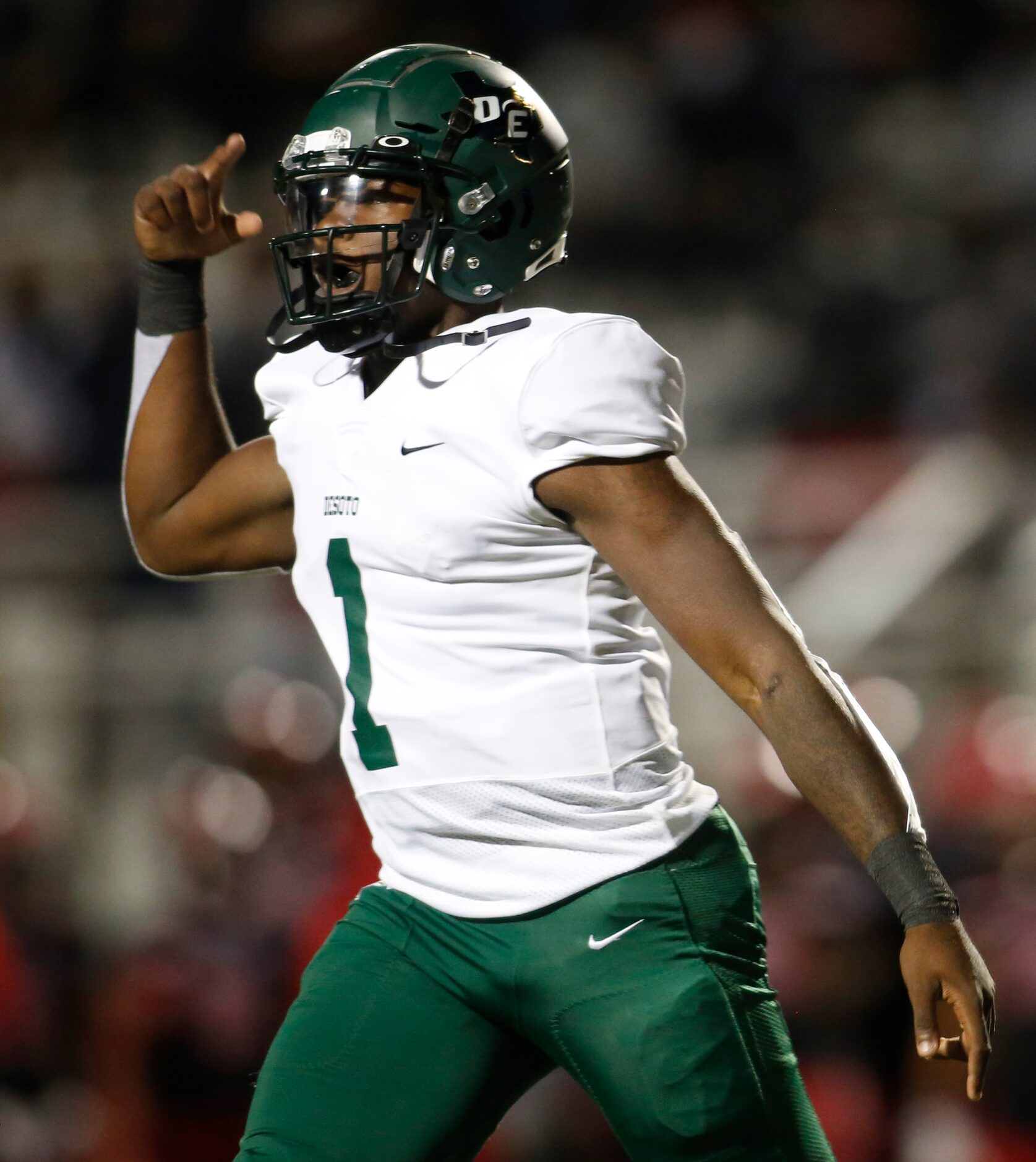 DeSoto quarterback Samari Collier (1) celebrates his rushing touchdown to break a scoreless...