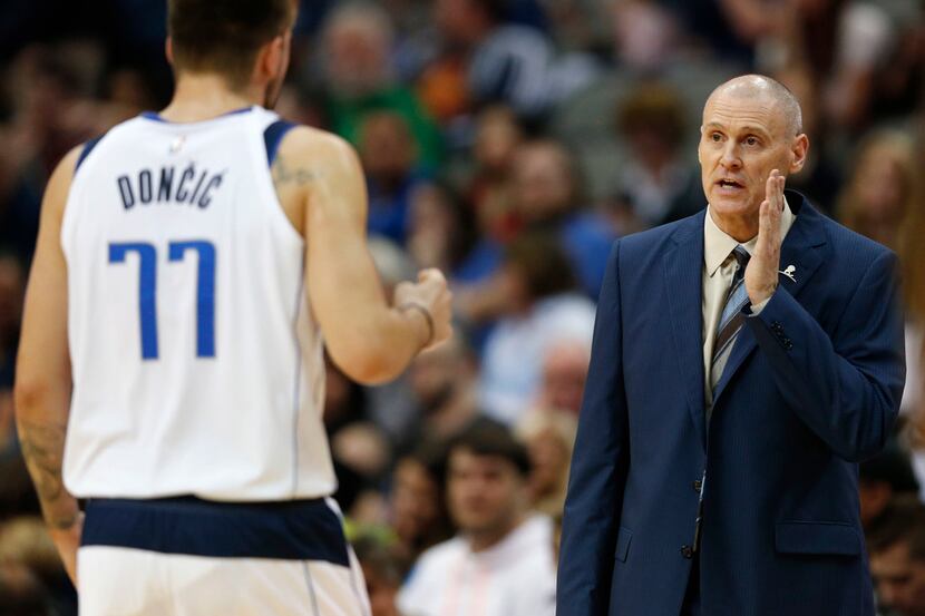Dallas Mavericks head coach Rick Carlisle talks with Dallas Mavericks guard Luka Doncic (77)...