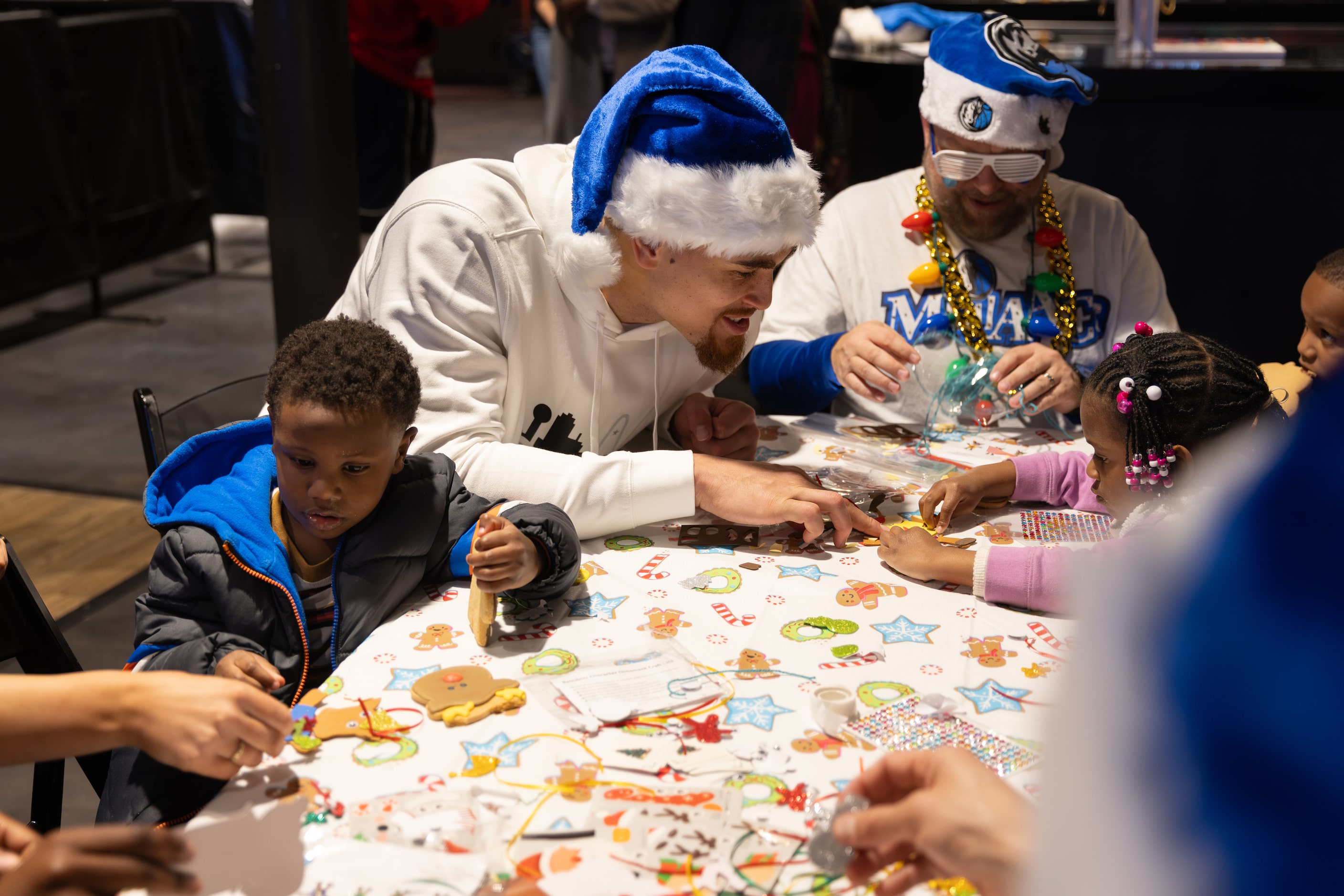 Mavericks forward-center Dwight Powell helps kids with arts and crafts during the Cookies...