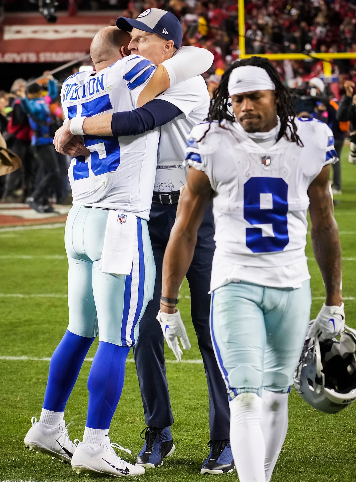 Dallas Cowboys special teams coordinator John Fassel hugs long snapper Matt Overton (45) as...