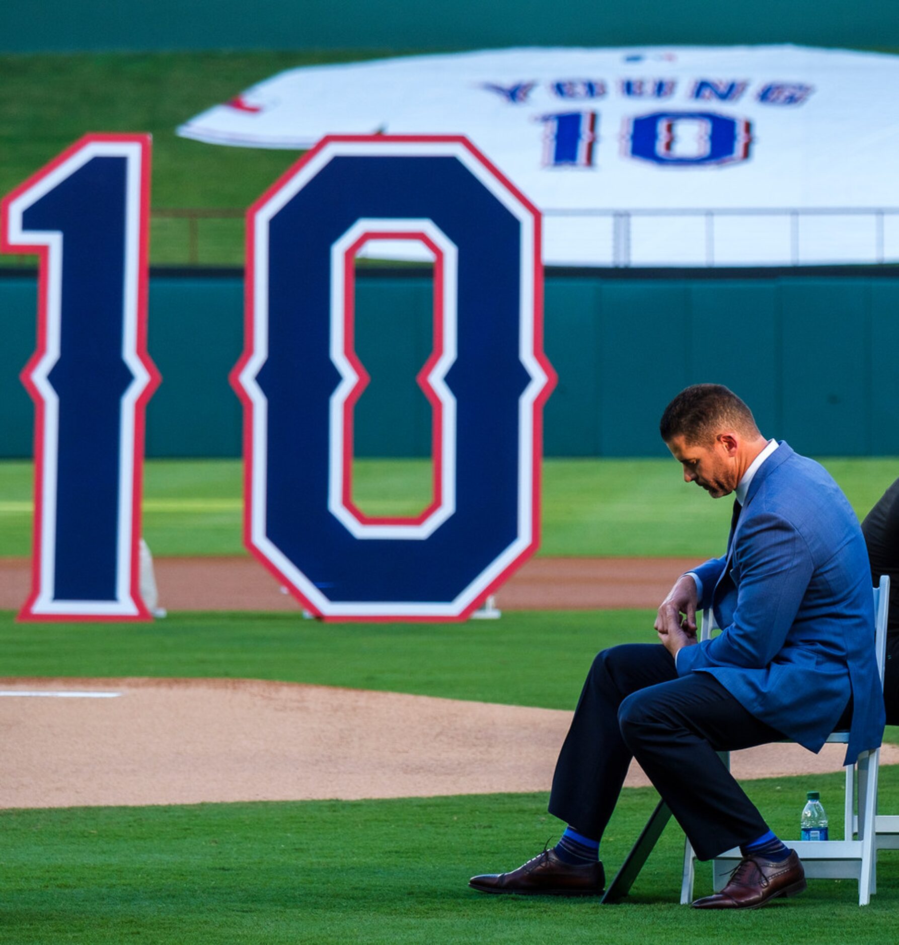 Michael Young looks down while a video tribute plays during ceremonies to retire Young's No....