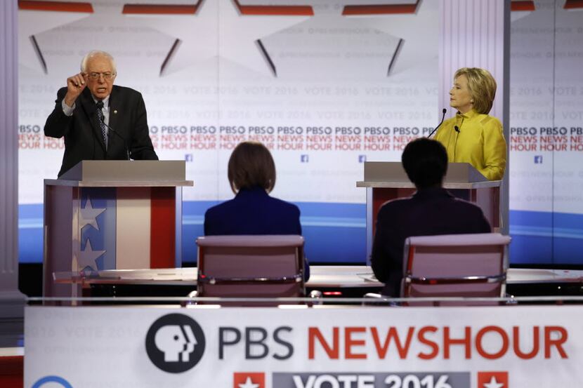  Democratic presidential candidate, Sen. Bernie Sanders, I-Vt, left, argues a point as...