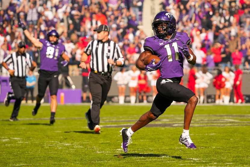 TCU wide receiver Derius Davis (11) races downfield on an 82-yard punt return for a...