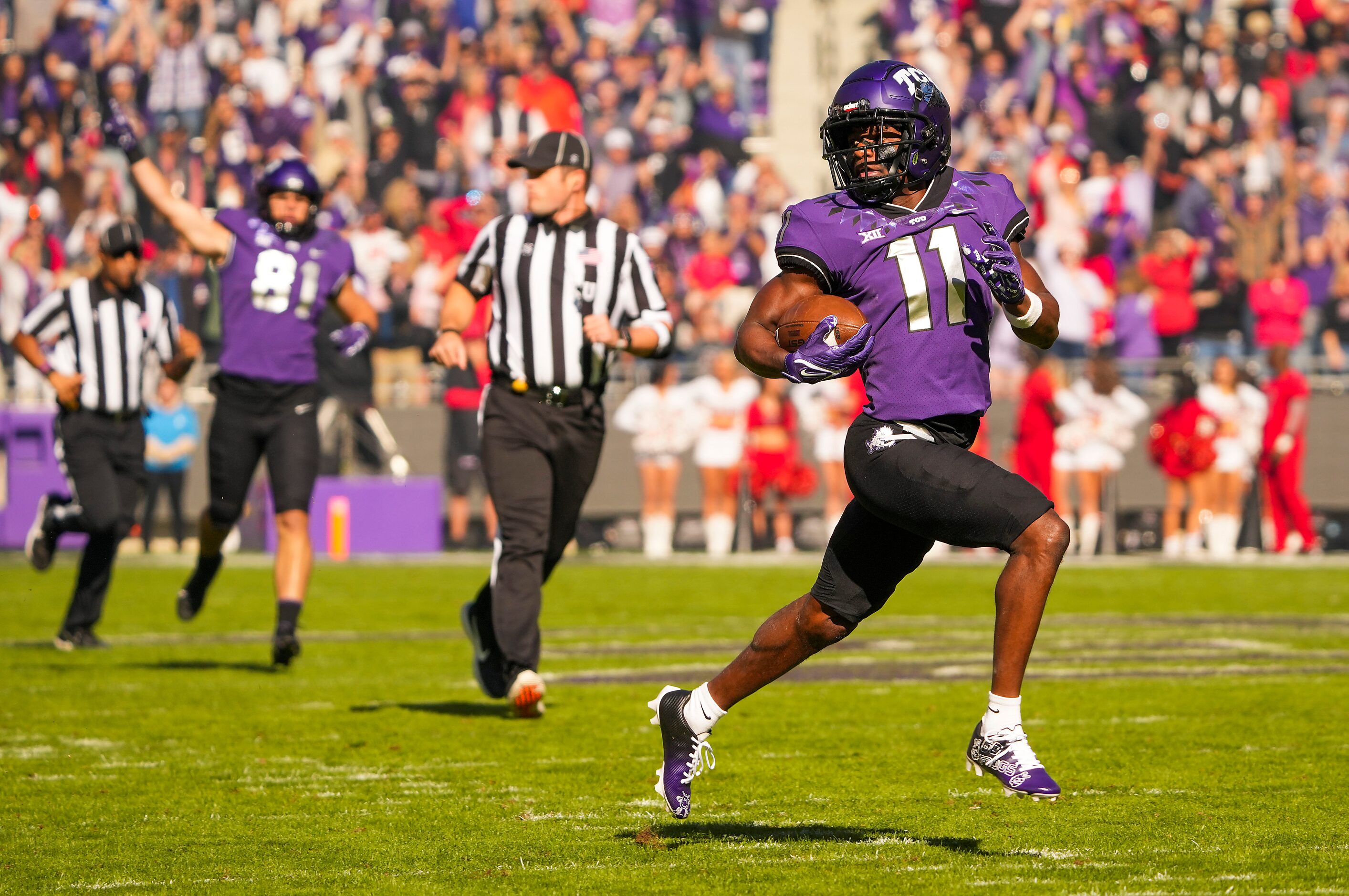 TCU wide receiver Derius Davis (11) races downfield on an 82-yard punt return for a...