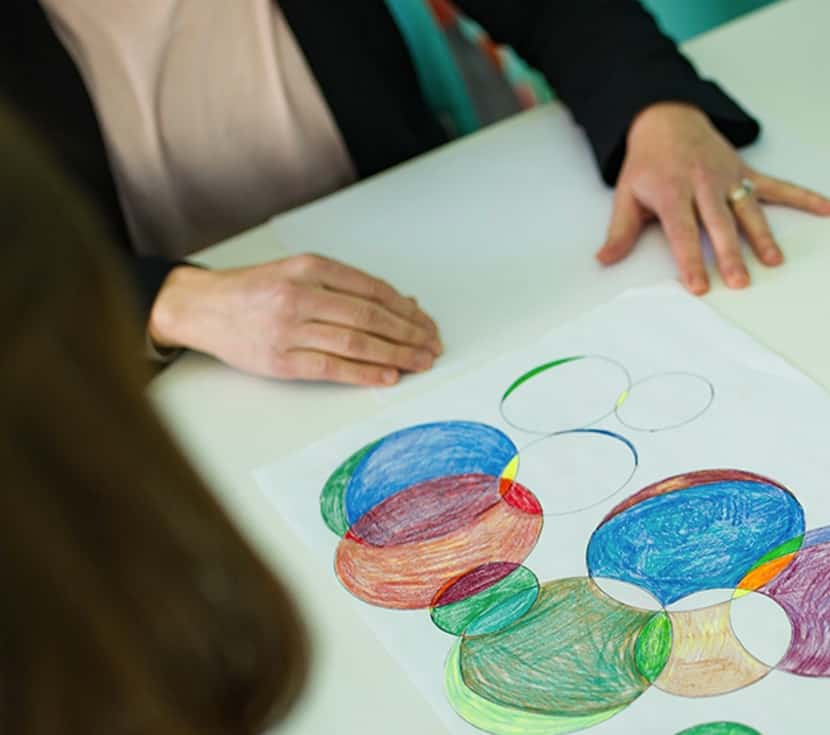 A therapist works with a client during an art therapy session at The Resiliency Center of...