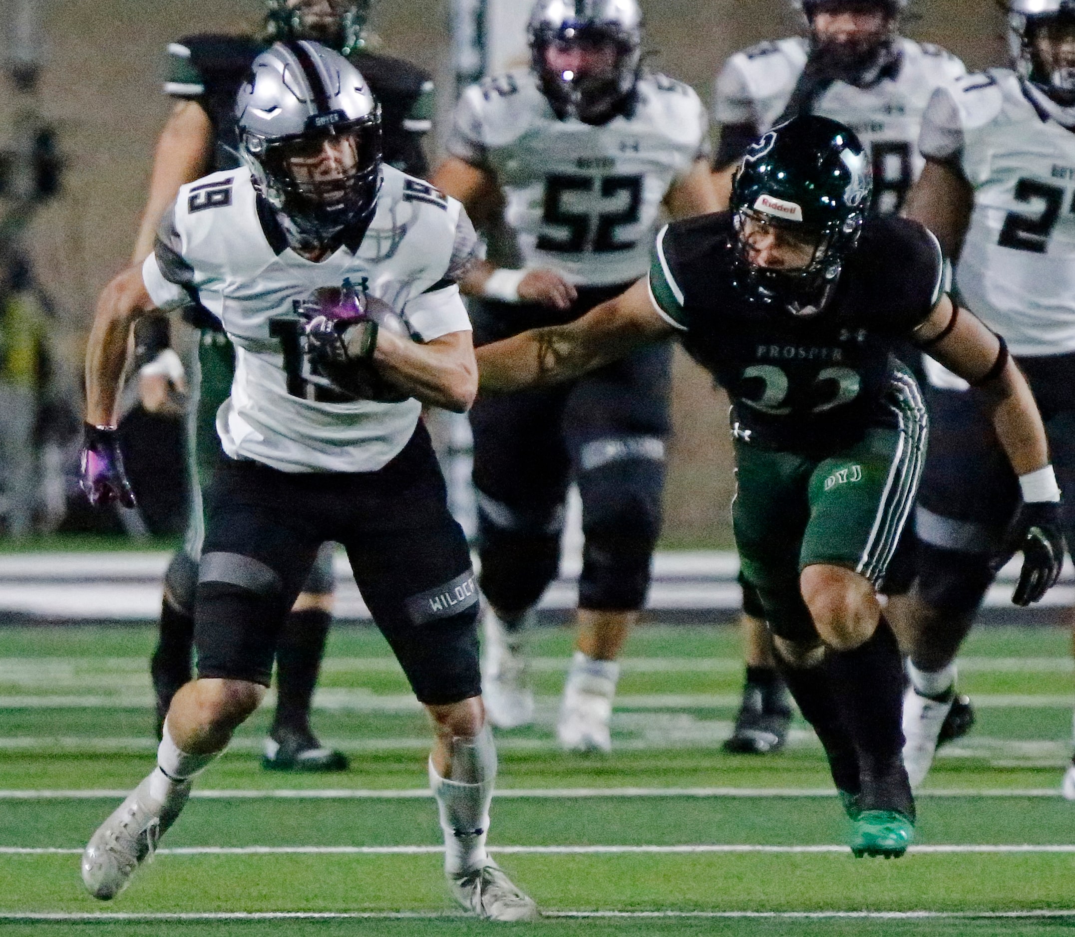 Denton Guyer High School wide receiver Grayson Obara (19) tries to run from Prosper High...