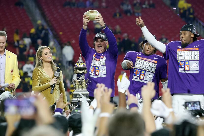 TCU coach Sonny Dykes holds up the Fiesta Bowl trophy after the team's win over Michigan in...