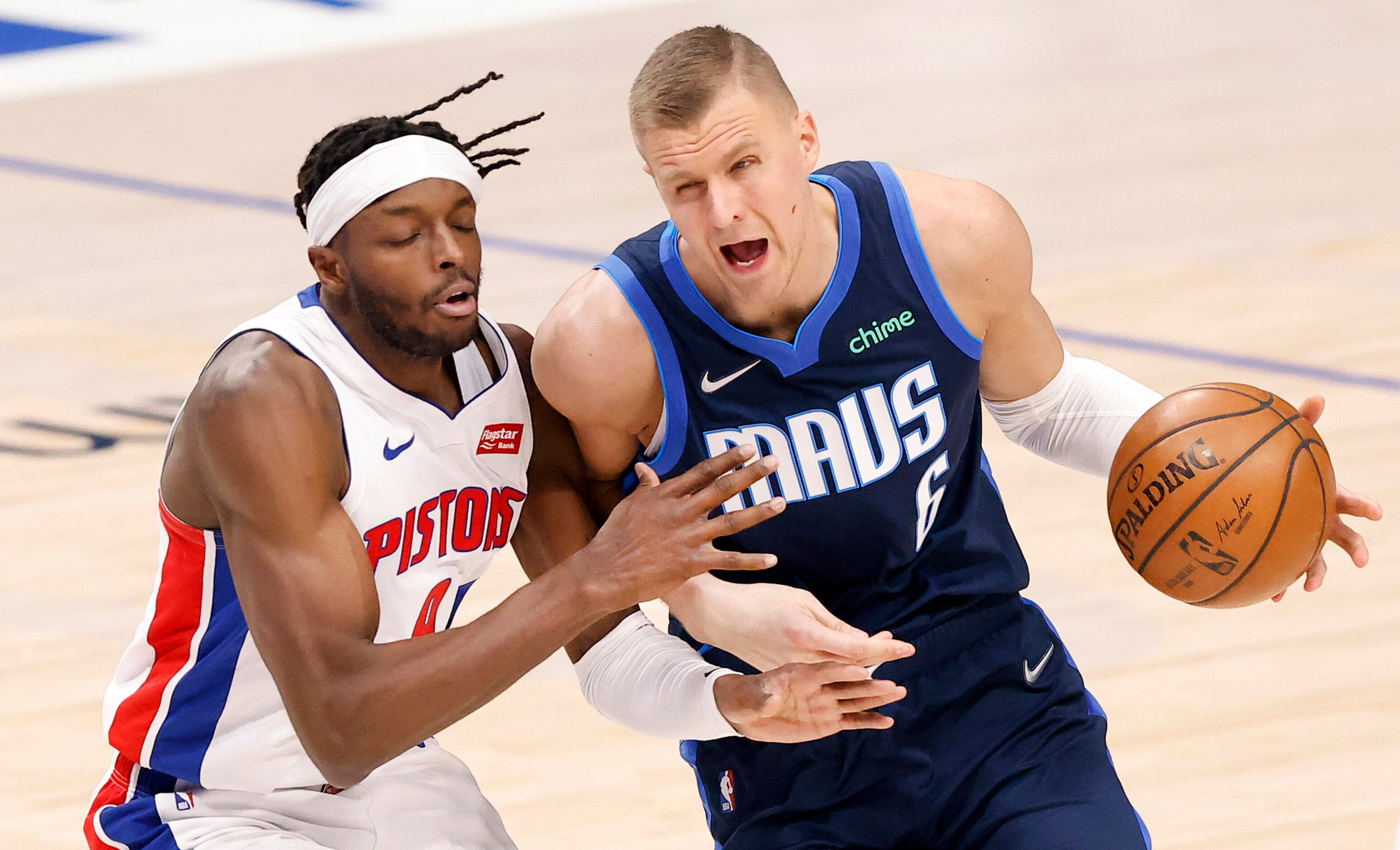 Dallas Mavericks center Kristaps Porzingis (6) is fouled by Detroit Pistons forward Jerami...