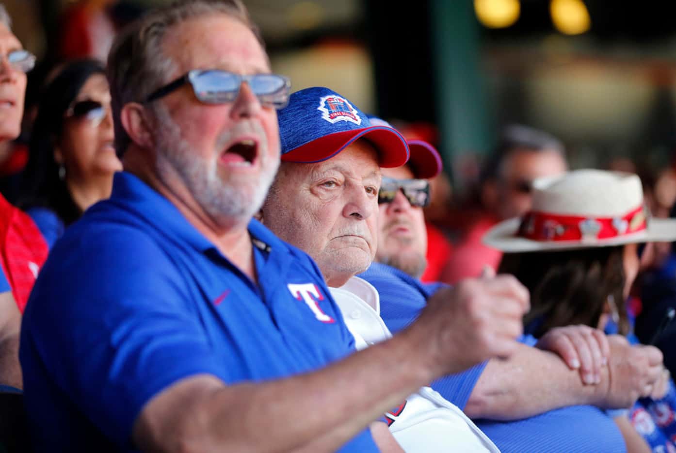 Zonk aka John Lanzillo Jr., 85, (center) watches the Opening Day game as the Texas Rangers...