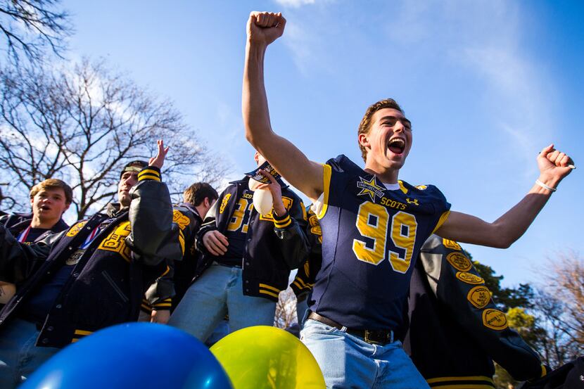 Highland Park defensive lineman Marshall Hammack (99) cheers from a float as the Highland...