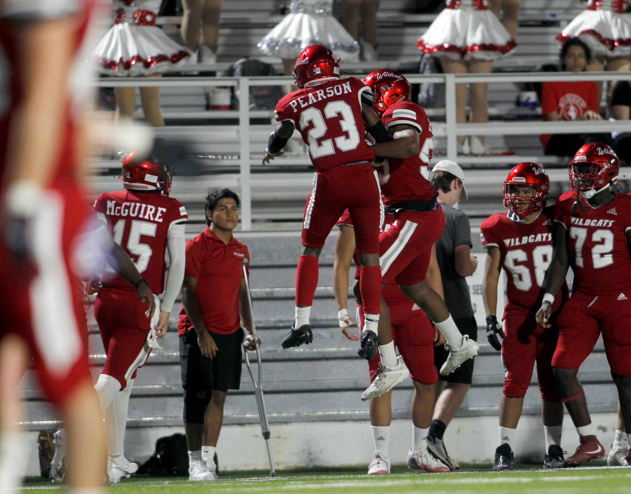 Dallas Woodrow Wilson running back Keitron Pearson (23) skies with a teammate in celebration...