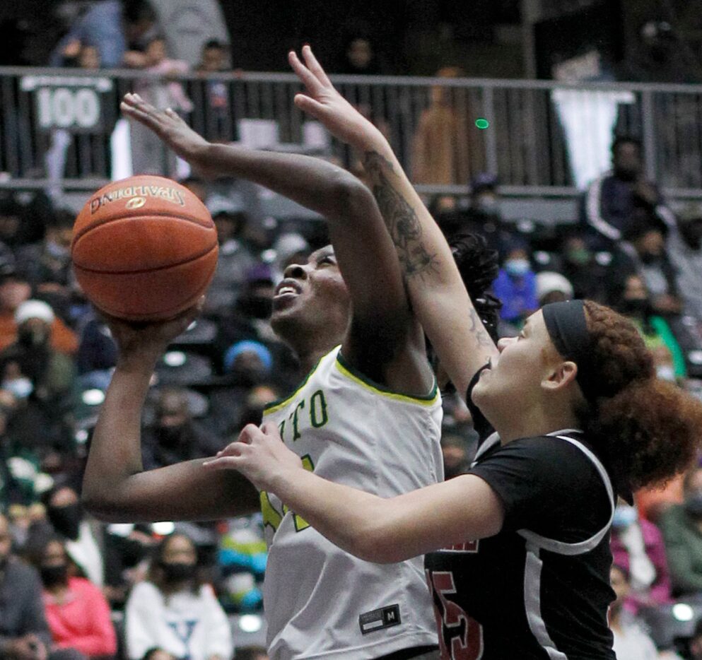 DeSoto guard Amina Muhammad (14), left, shoots against the defense of Duncanville guard...