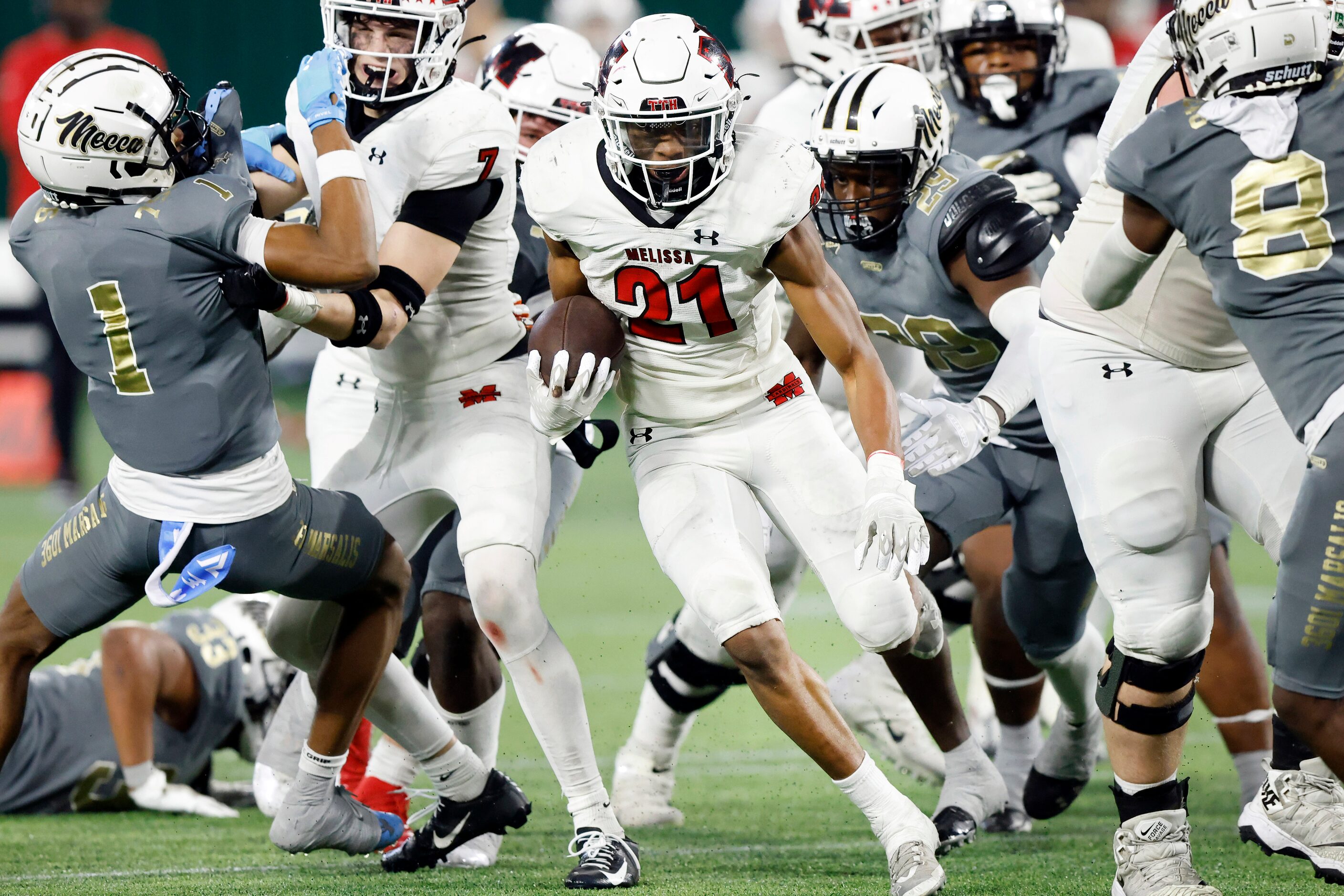 Melissa running back Nathan Adejokun (21) breaks through the South Oak Cliff defensive line...