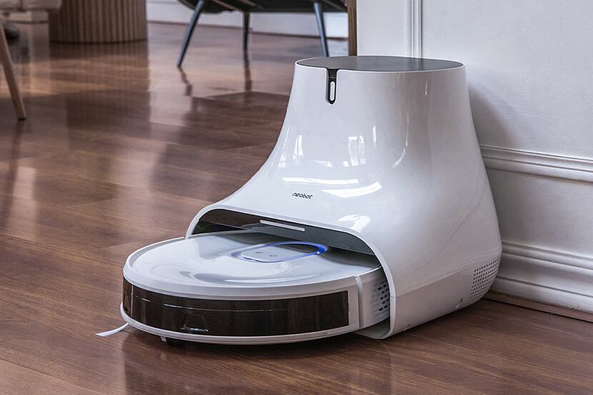The Neabot Nomo Q11 Robot Vacuum and Mop is shown on its charging base.