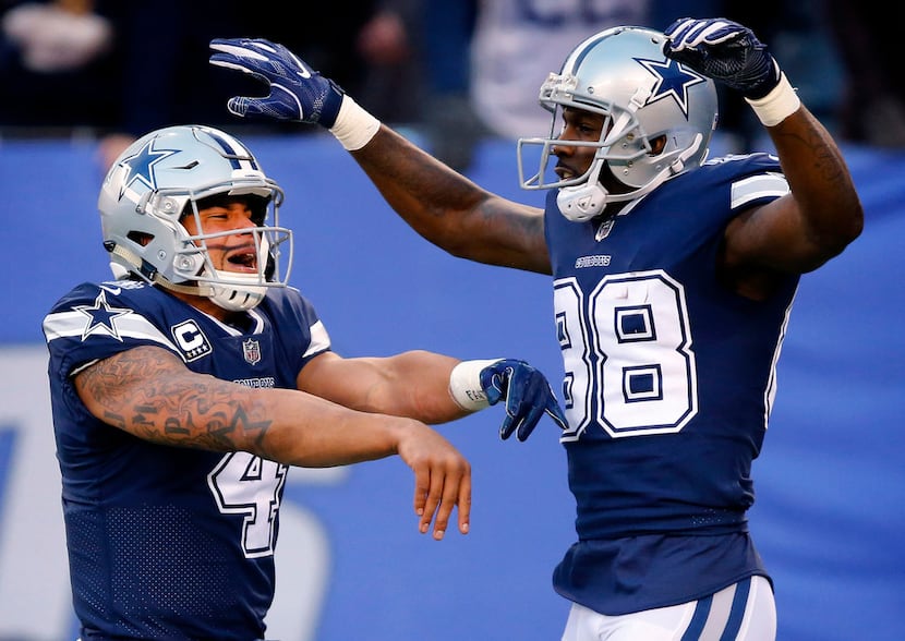 Dallas Cowboys quarterback Dak Prescott and wide receiver Dez Bryant celebrate running back...