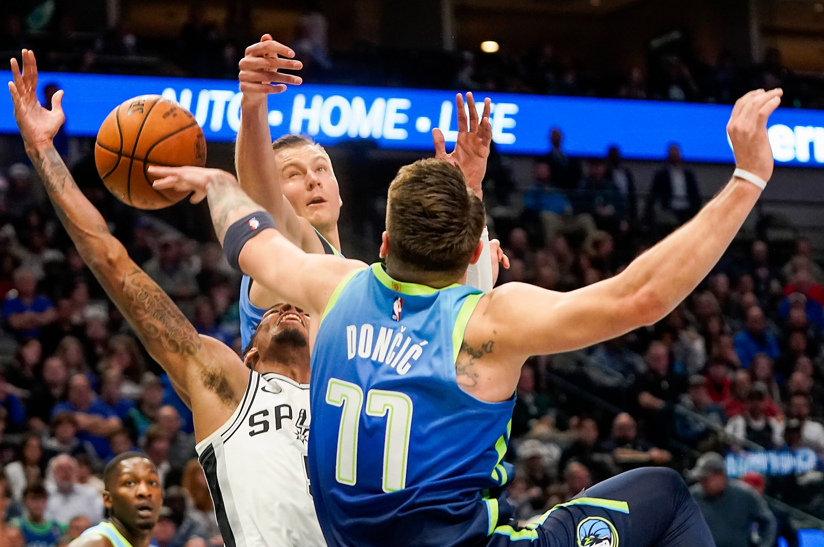 Dallas Mavericks guard Luka Doncic (77) knocks the ball away from San Antonio Spurs guard...