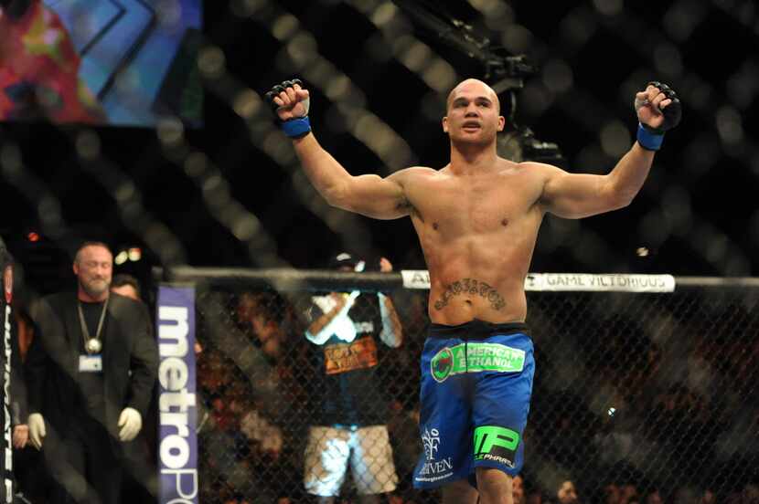 Nov 16, 2013; Las Vegas, NV, USA; Robbie Lawler (blue gloves) celebrates after his...