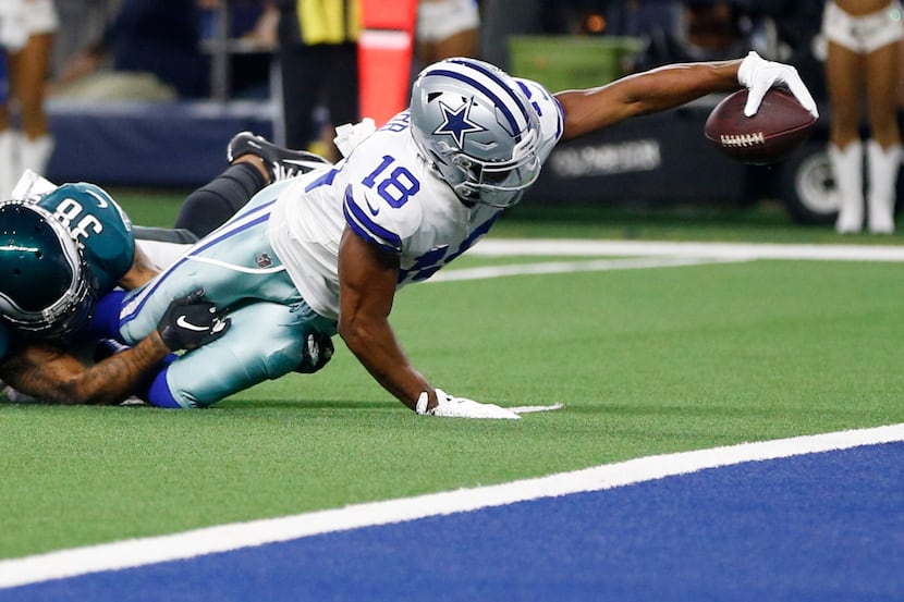 Dallas Cowboys wide receiver Randall Cobb (18) stretches for more yards as he is tackled by...