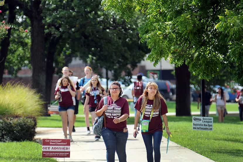 Texas Woman's University freshman Diana Salinas and Ariana Cortez, make their way across...