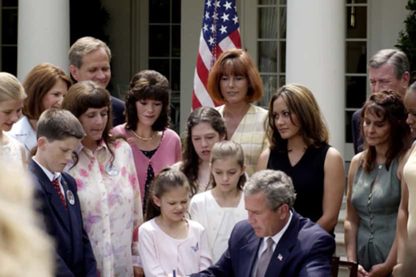  Former President George W. Bush signs the PROTECT Act at the White House in 2003. (National...
