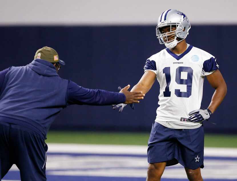 Dallas Cowboys running backs coach Gary Brown greets Dallas Cowboys receiver Amari Cooper...