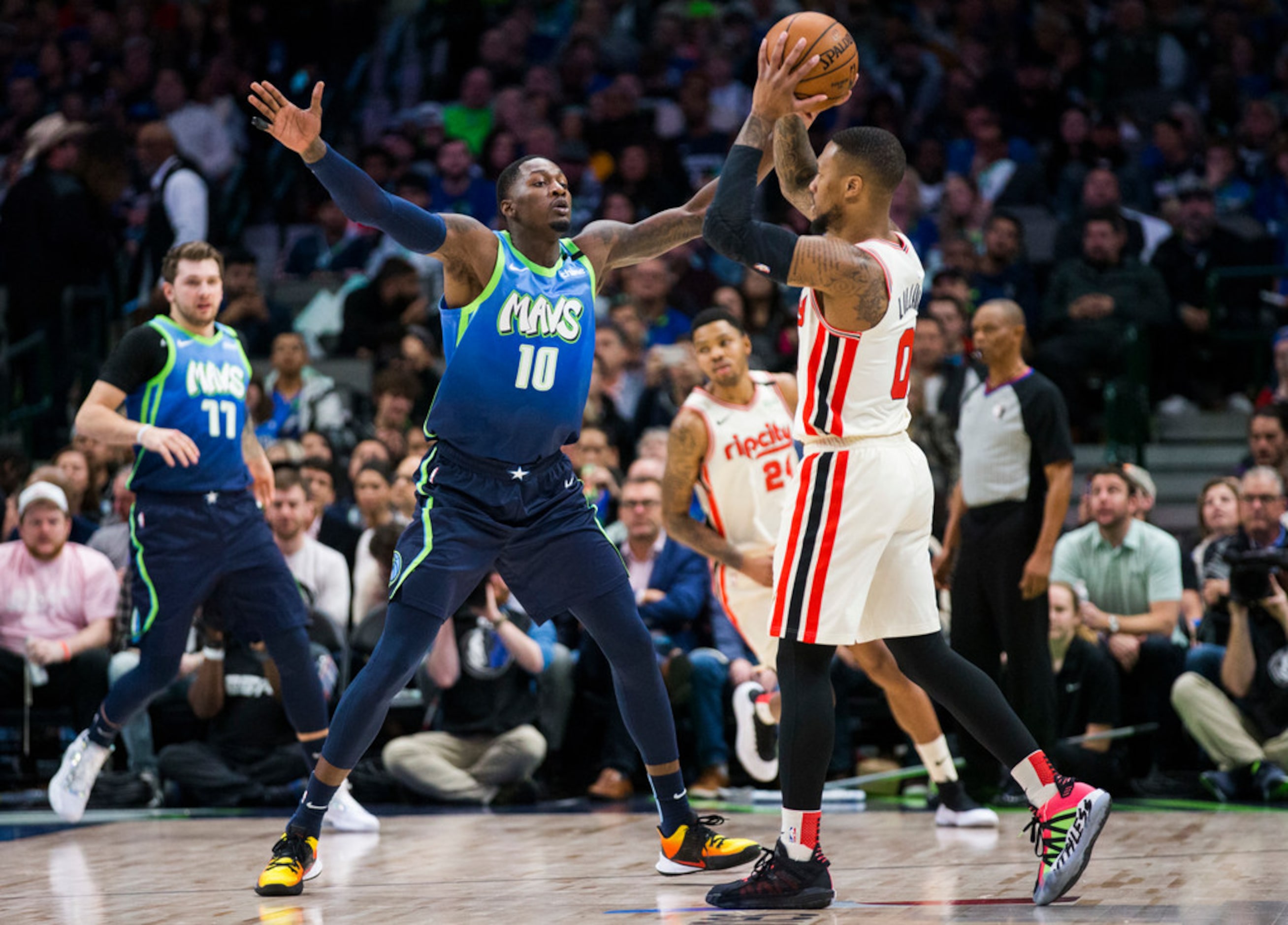 Dallas Mavericks forward Dorian Finney-Smith (10) defends Portland Trail Blazers guard...