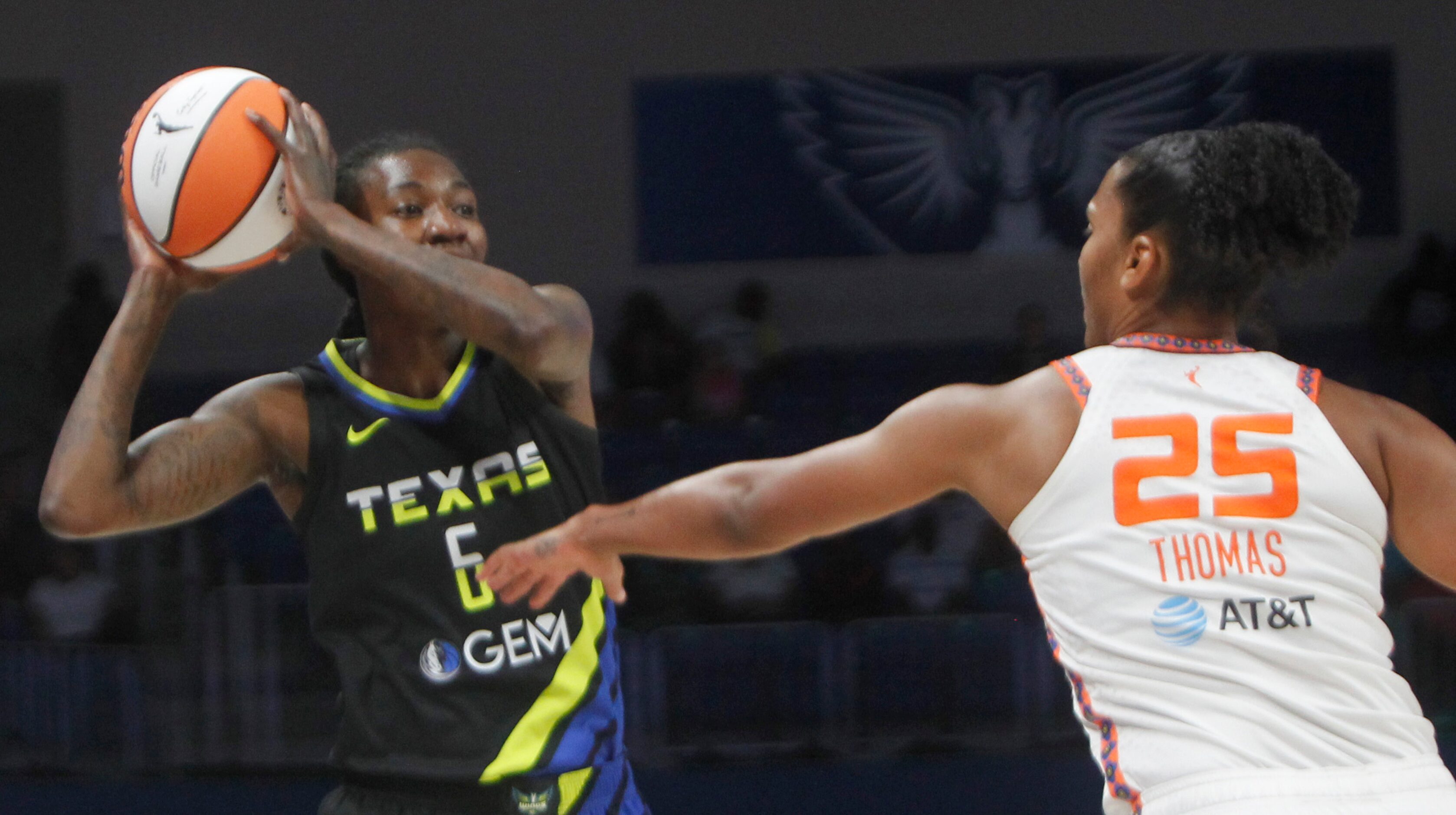 Dallas Wings forward Natasha Howard (6) looks to pass as she is defended by Connecticut Sun...