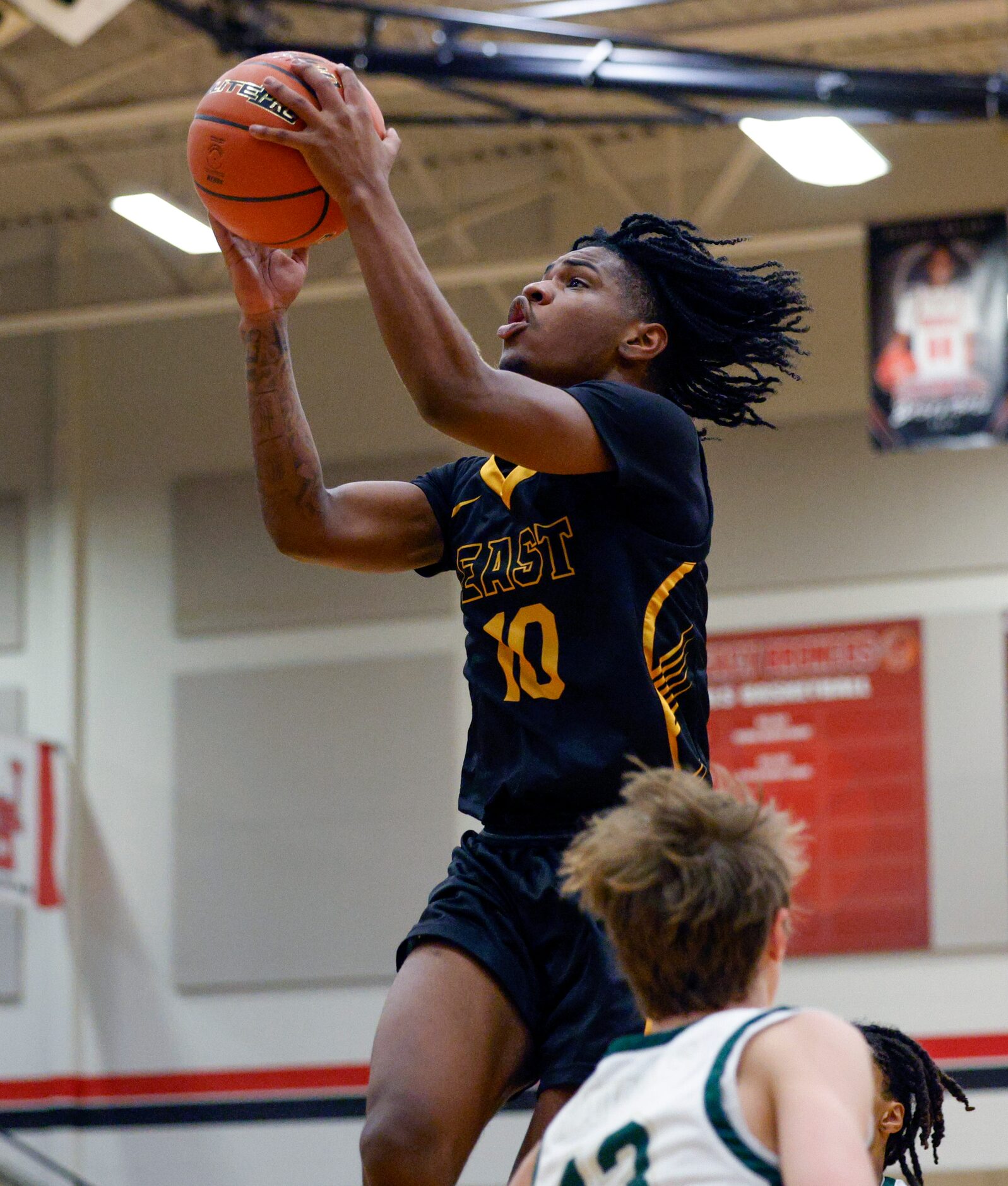 Plano East wing Xavier Miller (10) drives to the basket during the first half of a...