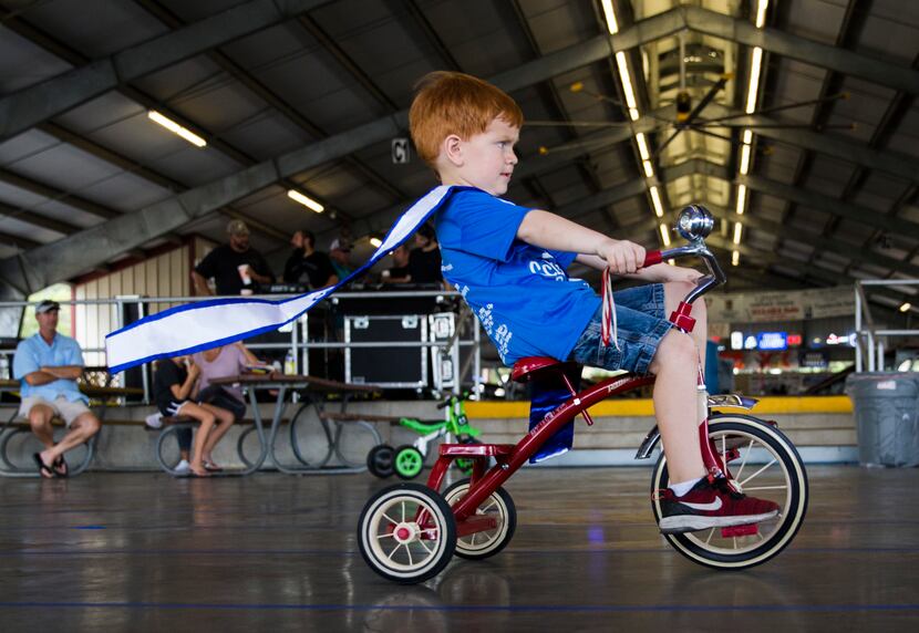 Little Mister Schulenburg Clay Hoffman, 4, participates in the tricycle races during the...