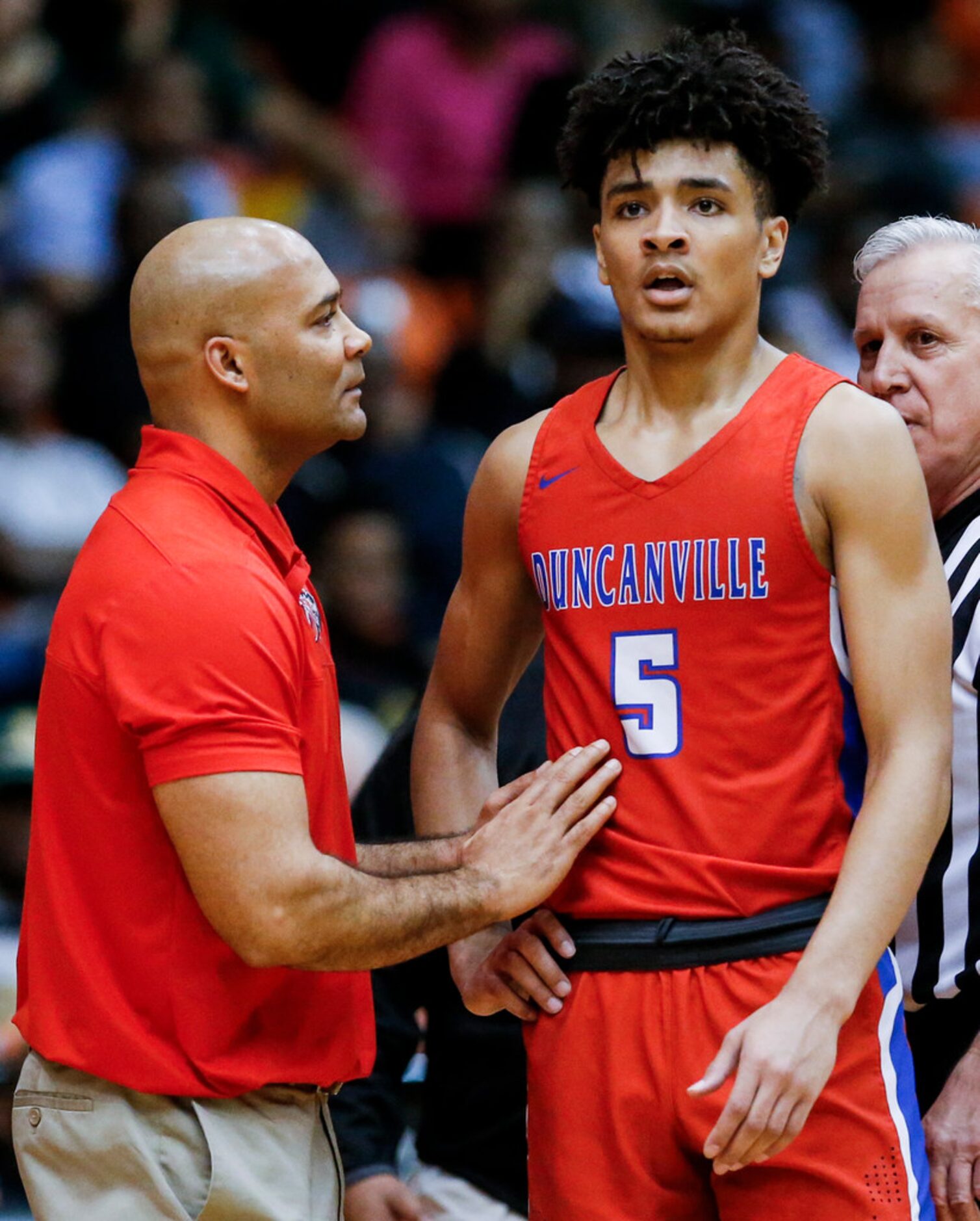 Duncanville head coach David Peavy gives instructions to his son, junior guard Micah Peavy...