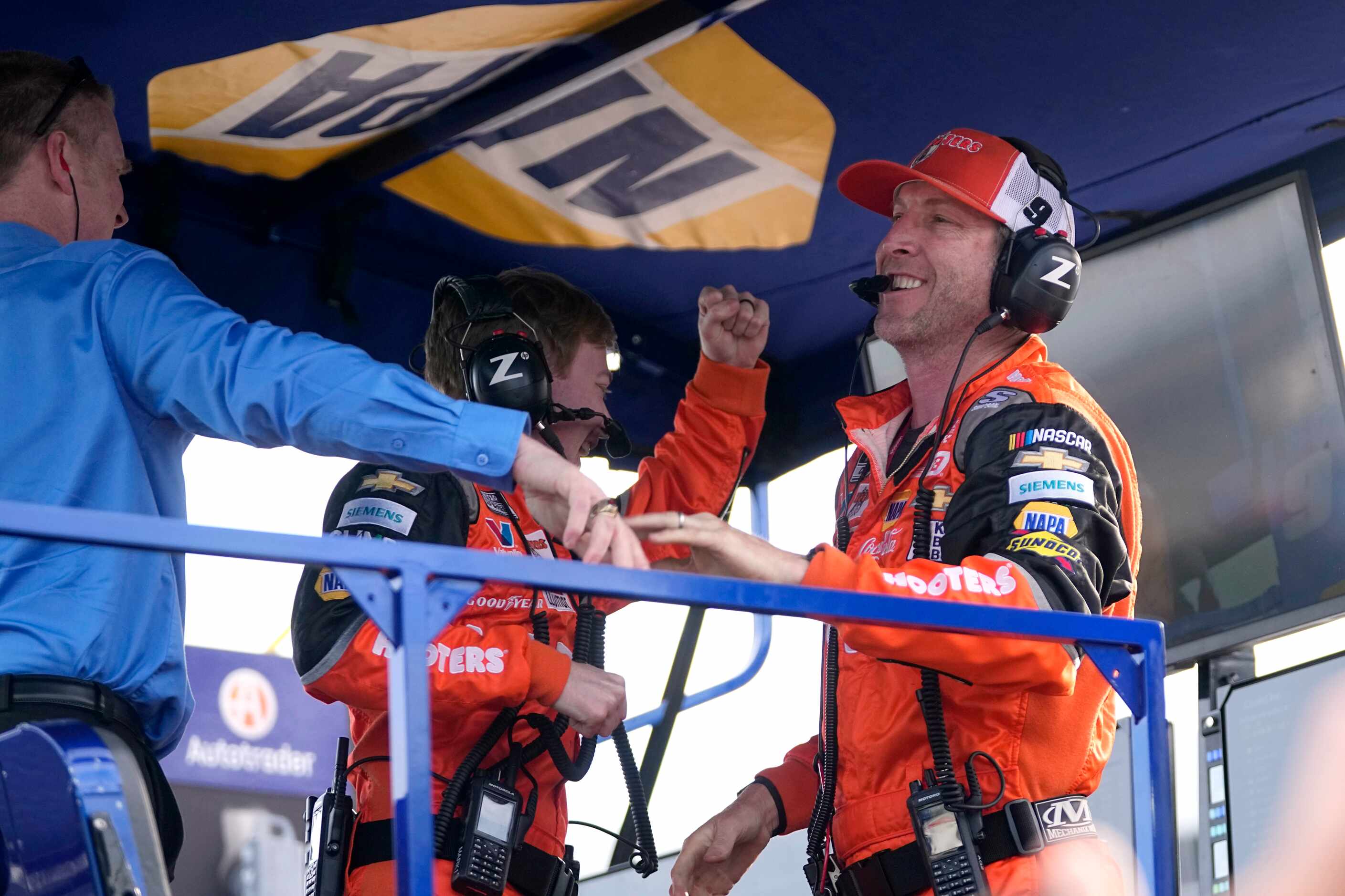 Chase Elliott's crew chief Alan Gustafson, right, celebrates with team members after winning...