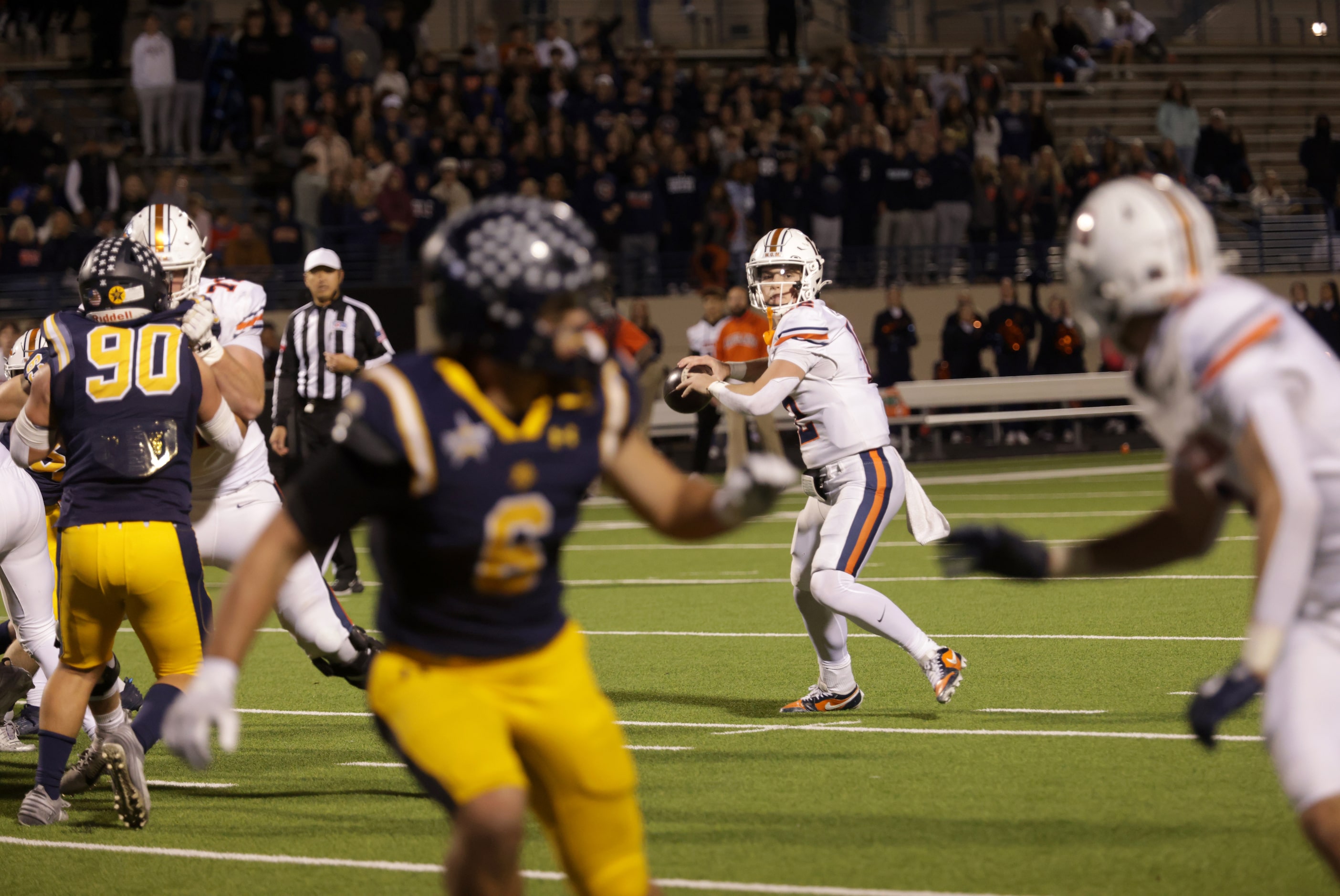 Frisco Wakeland quarterback Jayden Maples looks for an open receiver in a football playoff...