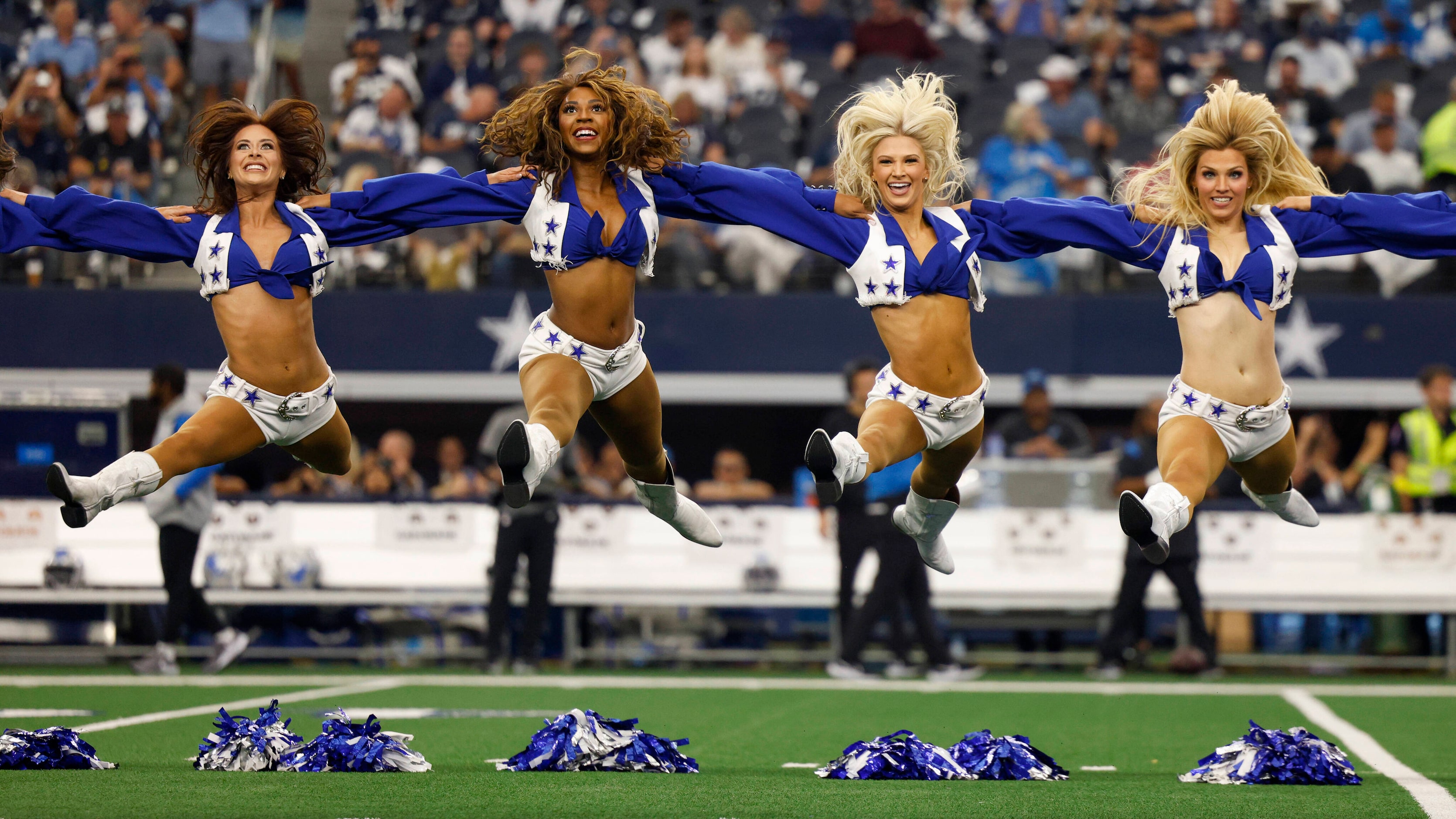 The Dallas Cowboys cheerleaders perform before a NFL game against the Detroit Lions at AT&T...