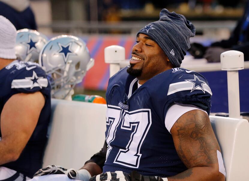 Dallas Cowboys offensive tackle Tyron Smith (77) smiles as he sits on the bench during the...